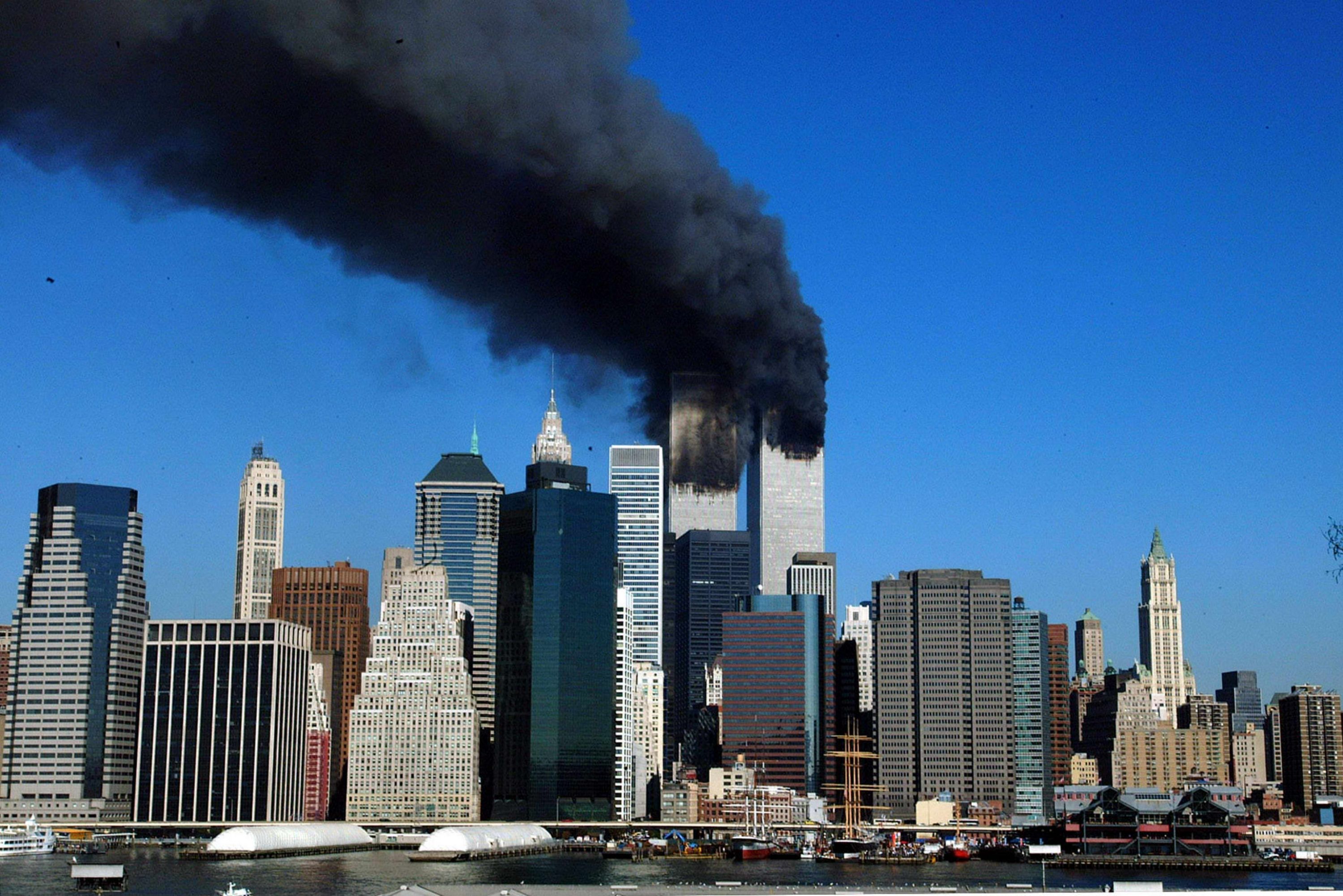 The twin towers of the World Trade Center billow smoke after hijacked airliners crashed into them early 11 September, 2001. The suspected terrorist attack has caused the collapsed of both towers. AFP PHOTO/Henny Ray ABRAMS (Photo credit should read HENNY RAY ABRAMS/AFP via Getty Images)